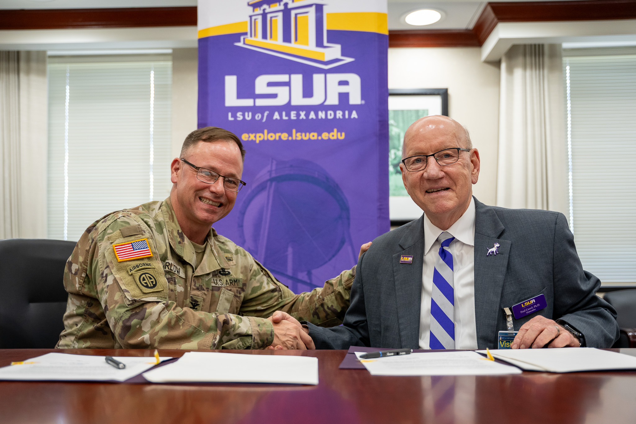 Col. Adam Barlow, Fort Polk Garrison Commander, and Dr. Paul Coreil, LSUA Chancellor, shaking hands