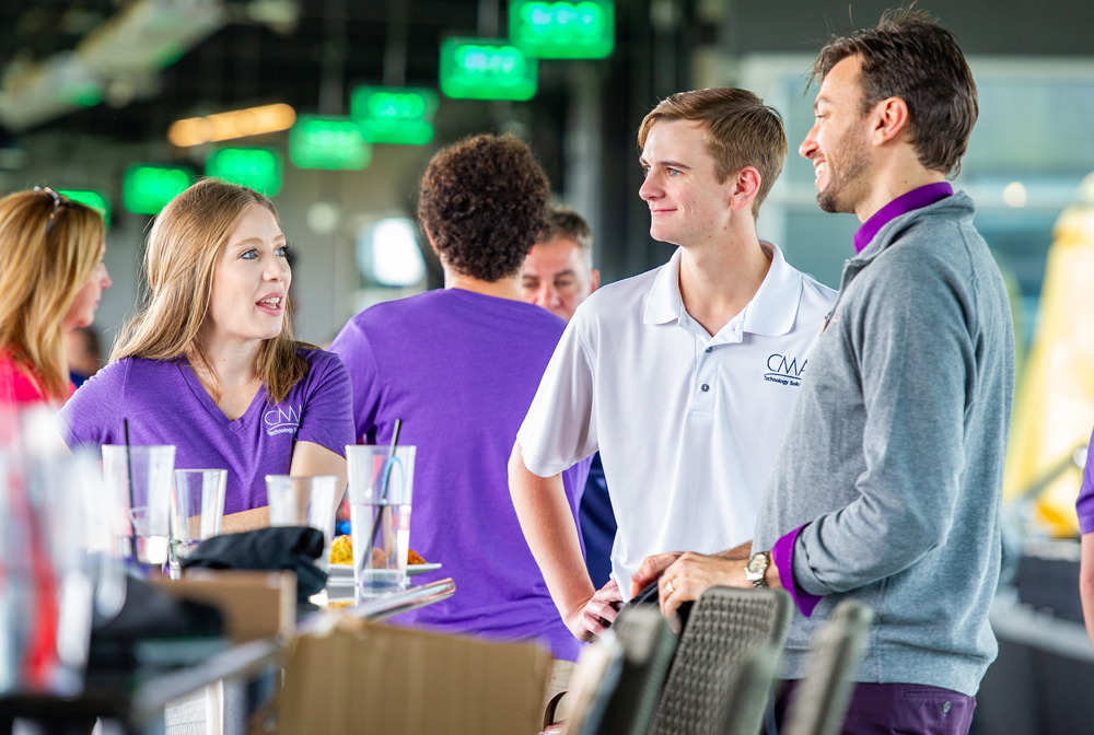 Faculty speak with corporate partners at the tournament