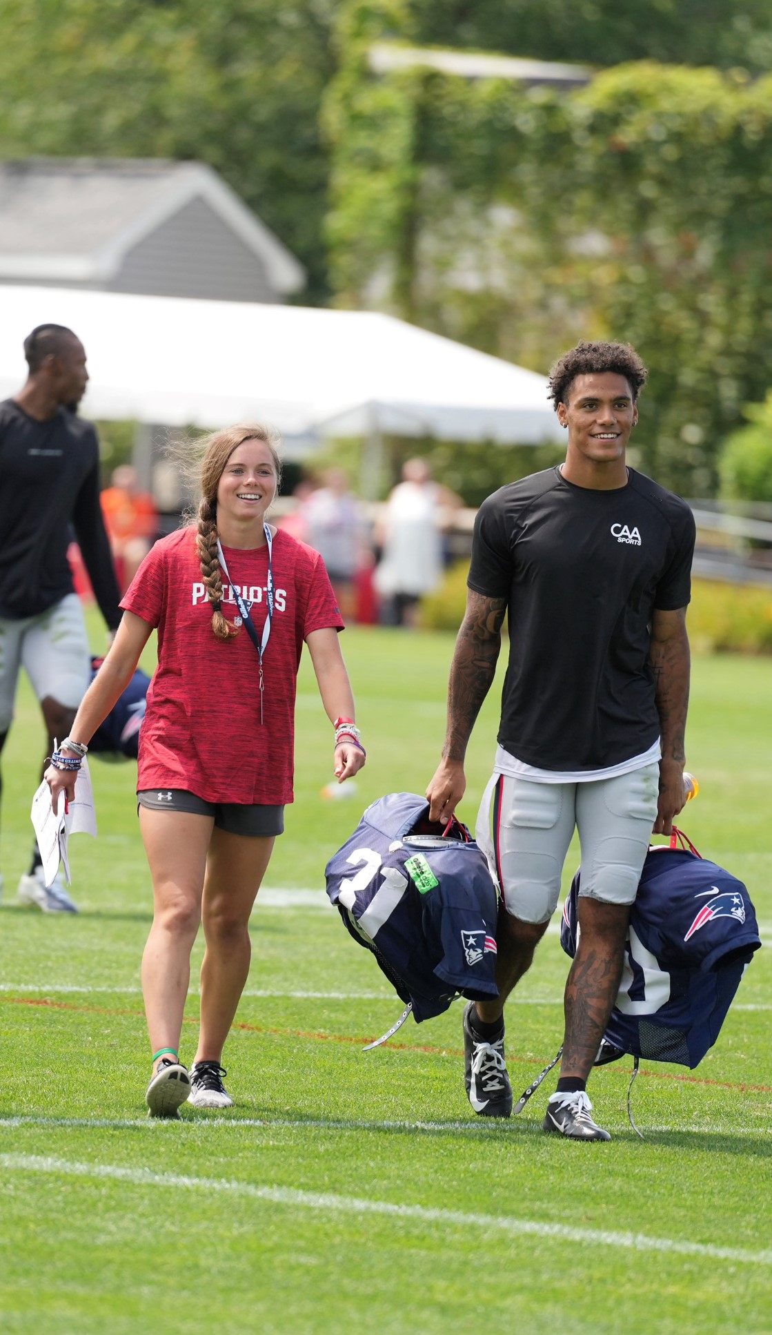 woman walks with football player