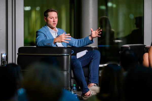 Brandon Landry speaking on a stage