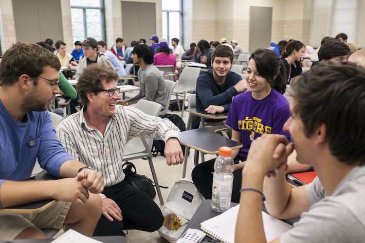 faculty speaking with group of students