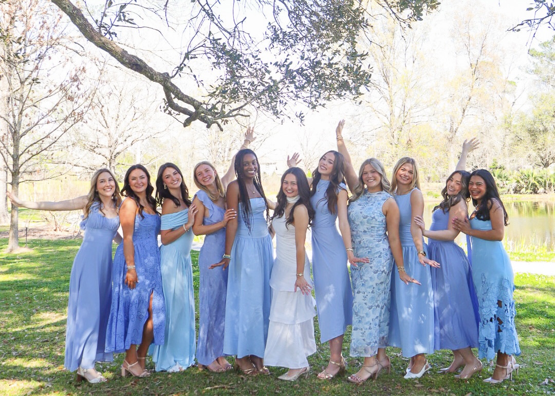 ADPI members in blue dresses pose