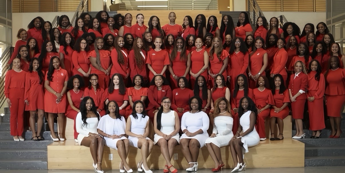 Delta Sigma Theta members pose in front of steps in all red