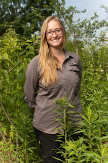 Caitlin Robbins standing in garden