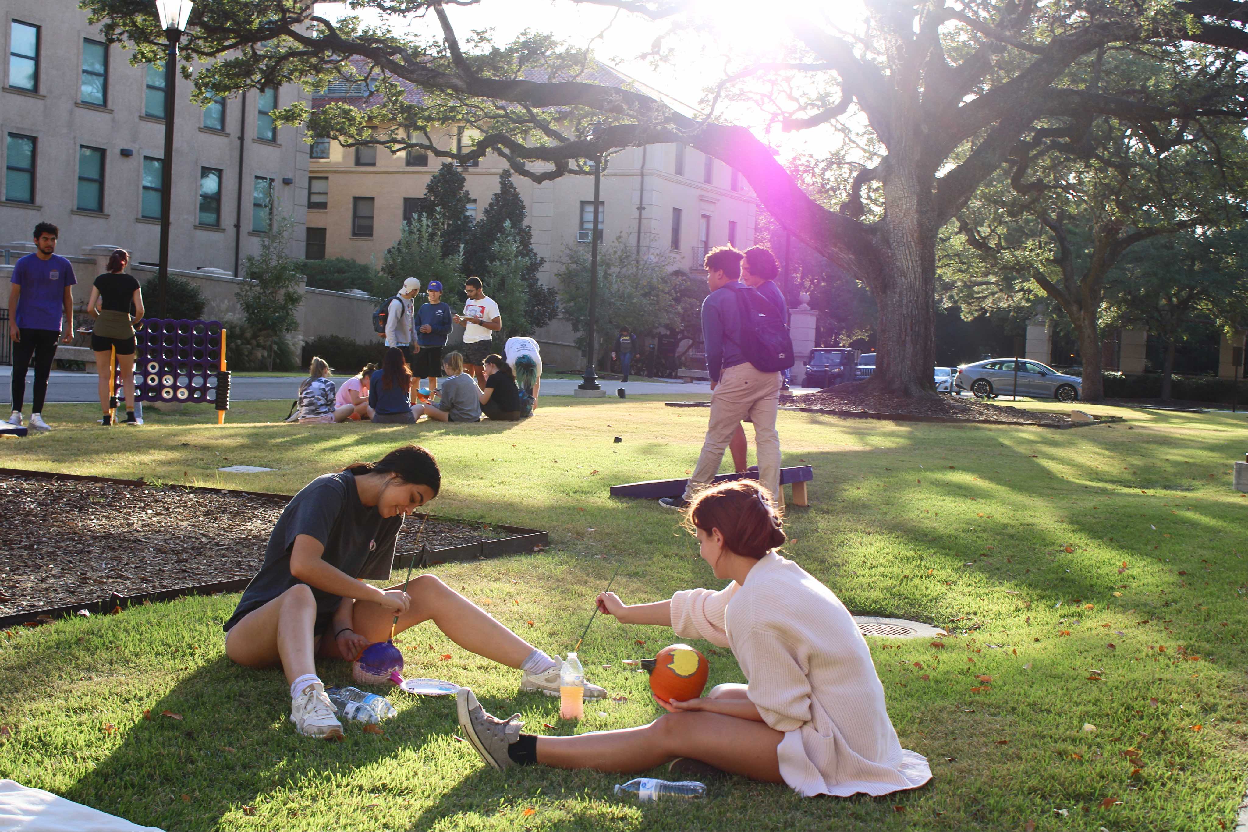 Residents painting pumpkins in the Horseshoe Community courtyard