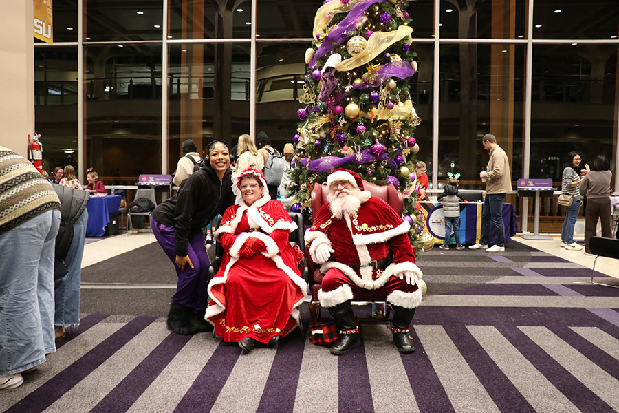 student with Santa and Mrs. Claus